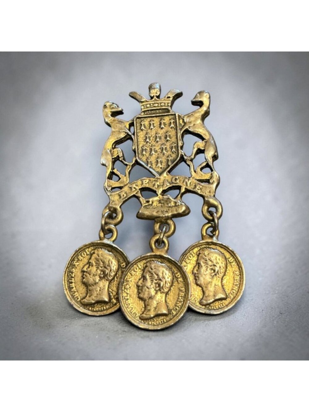 Vintage Coat Of Arms Brooch With Dangling French Coin Motif Gold-Tone 2x1 Inches